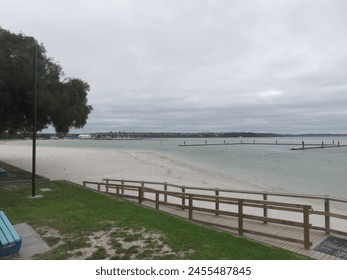Serene Beachscape with Wooden Walkway and Overcast Sky - Powered by Shutterstock