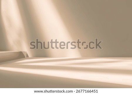 A serene beige interior with soft light casting gentle shadows across a minimalist space.