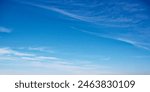 A serene blue sky with wispy clouds, suggesting calmness, ideal for backgrounds or meditation visuals. Expansive azure sky with delicate cloud streaks, evoking tranquility.