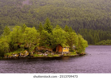 A serene cabin nestled on a tiny forested island in Aheim, surrounded by lush greenery and calm waters - Powered by Shutterstock