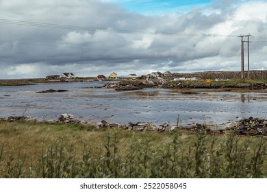 Serene Coastal Landscape in Lofoten Islands, Nordland Showcasing Fishing Activity in a Picturesque Wetland Under Cloudy Skies - Powered by Shutterstock