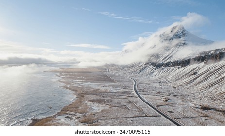 Serene Coastal Landscape with Snow-Covered Mountain Peak - Powered by Shutterstock