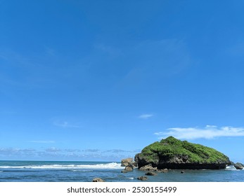 Serene Coastal Rock Formation at Sadranan Beach Under a Clear Blue Sky - Powered by Shutterstock