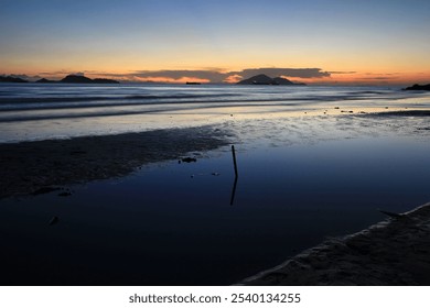 Serene Coastal Sunset with Vibrant Sky Reflections, Hong Kong - Powered by Shutterstock