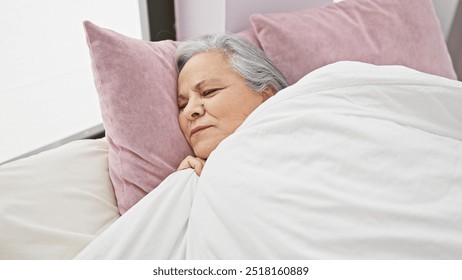 A serene elderly woman sleeps peacefully in a cozy bedroom setting, invoking a sense of relaxation and comfort. - Powered by Shutterstock