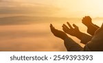 Serene embrace of nature, Christian man and woman worship Jesus Christ with hands raised in prayer, silhouetted against sunrise. worship, christian, morning, man, woman, jesus christ, sunrise.