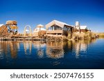 A serene floating island on Lake Titicaca, Peru, featuring traditional reed houses under a clear blue sky, reflecting the rich cultural heritage of the indigenous Uros people.