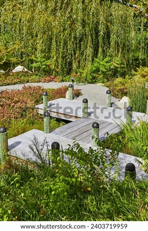 Serene Garden Pathway with Wooden Boardwalk and Weeping Willow