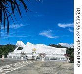 A serene image of a white Buddha statue, exuding tranquility and calm. The pure, luminous surface contrasts beautifully with its surroundings, embodying a sense of inner peace.