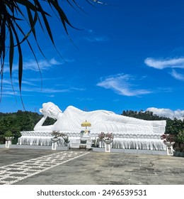 A serene image of a white Buddha statue, exuding tranquility and calm. The pure, luminous surface contrasts beautifully with its surroundings, embodying a sense of inner peace. - Powered by Shutterstock