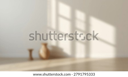 A serene interior scene featuring soft sunlight casting shadows on a neutral wall and floor, with pottery adding a touch of warmth and texture.