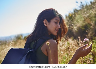 A Serene Lady Prayerfully Taking In Natures Flora With Closed Eyes While The Wind Blows Through Her Hair