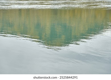 Serene lake reflection of lush green forest and clouded sky in peaceful nature setting. - Powered by Shutterstock