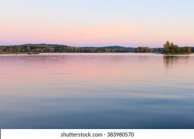 Serene lake scenery at dusk in Finland