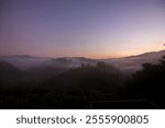 Serene landscape at dawn, showcasing rolling hills and misty valleys under a soft pastel sky, perfect for nature enthusiasts.