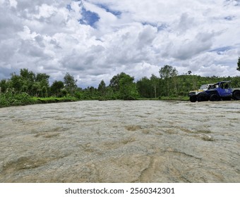 A serene landscape with a flowing river, lush greenery, and a rugged jeep parked by the riverside, blending adventure with nature's tranquility. - Powered by Shutterstock