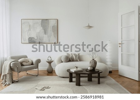 A serene living room with a neutral color palette, featuring a plush curved sofa, abstract artwork, and soft textures for a warm, modern aesthetic.