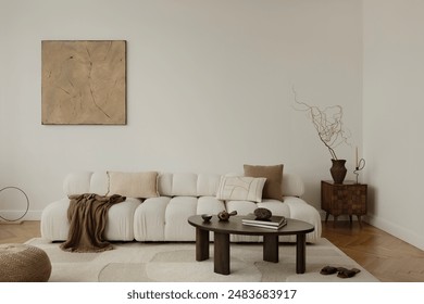 
A serene, minimalist living room with a plush, white sofa adorned with neutral cushions and a cozy blanket. A wooden coffee table, abstract wall art, and elegant decor complete the tranquil ambiance.