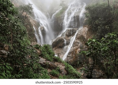 Serene Misty Waterfall in Lush Greenery - Powered by Shutterstock