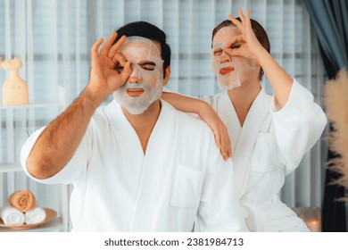 Serene modern daylight ambiance of spa salon, couple customer indulges in rejuvenating with facial skincare mask. Facial skin treatment and beauty cosmetology procedure for face. Quiescent - Powered by Shutterstock