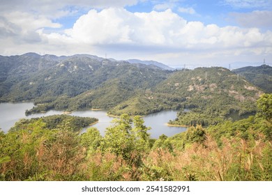 Serene Mountain Lake with Rolling Hills and Blue Sky - Powered by Shutterstock