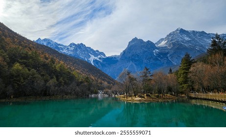 Serene Mountain Lake with Snow-Capped Peaks and Forest Reflections, Lijiang, China - Powered by Shutterstock