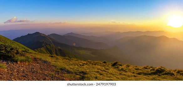 A serene mountain landscape on a summer evening. Beautiful panorama from the top of the mountain - Powered by Shutterstock