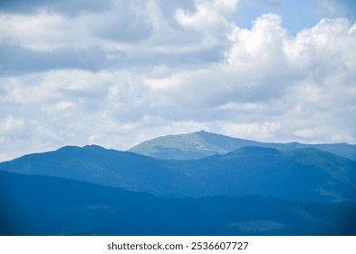 Serene mountain landscape of Pip Ivan Chonohora mountain peak with old observatory under a cloudy blue sky. Picturesque view capturing the tranquility and majesty of nature. Carpathians, Ukraine - Powered by Shutterstock