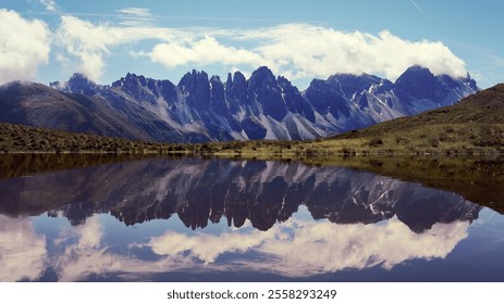 Serene mountain reflection in a calm lake during midday under a clear sky - Powered by Shutterstock