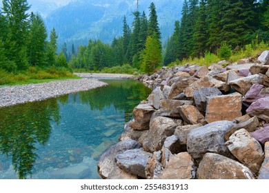 A serene mountain river flows through a lush, green forest, its clear, turquoise waters reflecting the surrounding vegetation and rocky shoreline. - Powered by Shutterstock