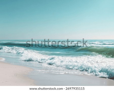 Serene ocean waves gently lapping onto a sandy shore under a clear blue sky.