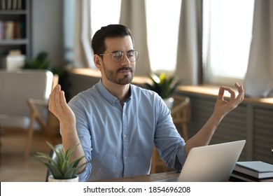 Serene Office Male Employee Sit At Desk Relaxing Doing Yoga, Practice Meditation To Reduce Stress Relief Fatigue Feel Internal Balance At Workplace, Improve Mindfulness, Maintain Mental Health Concept