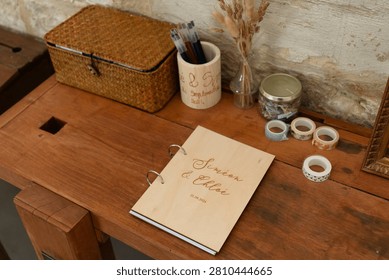 A serene and organized workspace featuring a rustic wooden desk with a neatly arranged selection of stationery and office supplies, including a notebook, pen holder, washi tape, and other paper craft supplies, set against a calm and peaceful background.
