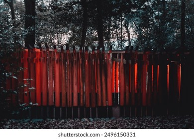 Serene Pathway Through Vibrant Torii Gates in a Tranquil Forest. Captivating image of traditional red torii gates illuminated in a serene forest setting.  - Powered by Shutterstock