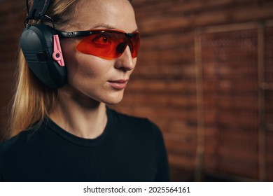 Serene Pretty Lady In Shooting Earmuffs Staring Into The Distance