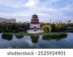 Serene Reflection of Traditional Architecture Surrounded by Lush Greenery  