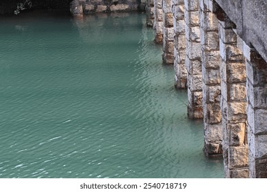 Serene Reflections: Stone Bridge Pillars Mirrored in Tranquil Waters - Powered by Shutterstock