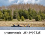 Serene Riverscape: Kayakers Glide Through Lush Landscapes, Embracing Nature