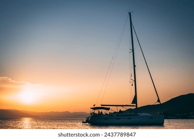 A serene sailboat gon calm waters, framed by a sky of sunset hues. Its elegance and stillness evoke timeless maritime allure. - Powered by Shutterstock
