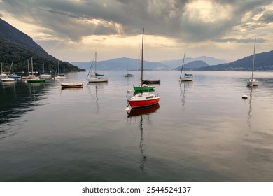 Serene Sailboats Docked on Calm Waters of Lake Como, Italy – A Peaceful Scenic View with Misty Hills and Tranquil Reflections - Powered by Shutterstock