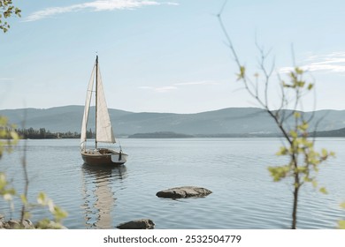 A serene scene of a sailboat gliding on a vast, calm lake - Powered by Shutterstock