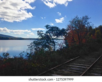 Serene Silver Lake With Railroad Tracks, Blue Sky, Clouds & Fall Trees In View, Madison New Hampshire