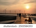 Serene sunset over the Gaomei Wetlands in Taichung, peaceful marshes and distant horizon create a tranquil scene.