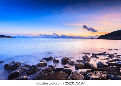 Serene Sunset Over a Rocky Beach in Cheung Chau, Hong Kong - Powered by Shutterstock