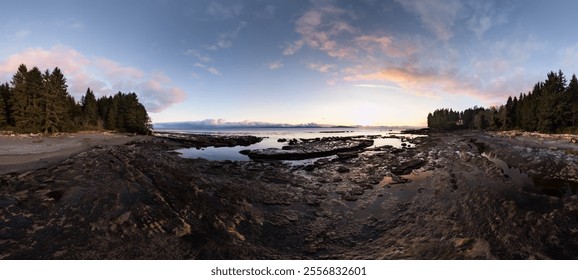 A serene sunset over a rocky beach on the West Coast of Vancouver Island, Canada, with a tranquil sky and evergreen forest. The scene captures the beauty of nature along the coastline. - Powered by Shutterstock