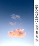 A serene twilight sky with soft pastel hues, featuring a vibrant, fluffy orange cloud against a calm blue background, radiating peaceful and dreamy vibes perfect for nature and atmospheric themes