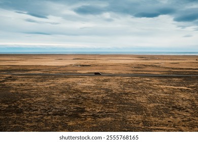 Serene and vast Icelandic landscape with solitary van driving through grassland in autumn at Iceland - Powered by Shutterstock