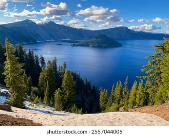 Serene view of Crater Lake, Oregon, featuring deep blue water, evergreen trees, and snow-covered slopes under a vibrant sky. Perfect for nature, travel, or scenic landscape inspiration. - Powered by Shutterstock