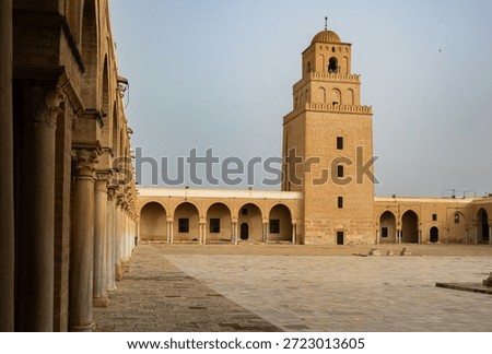 Serene view of empty expansive courtyard and towering minaret at Great Mosque of Kairouan, also known as Mosque of Uqba, in Tunisia