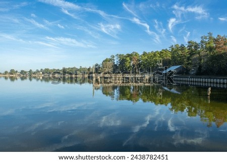 Serene view of Lake Livingston reservoir with nice coulds reflecting in  still waters in the East Texas Piney Woods in Polk County, Texas, United States